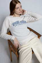 Load image into Gallery viewer, Woman wearing a 'Spring Valley University' sweatshirt sitting on a wooden chair.